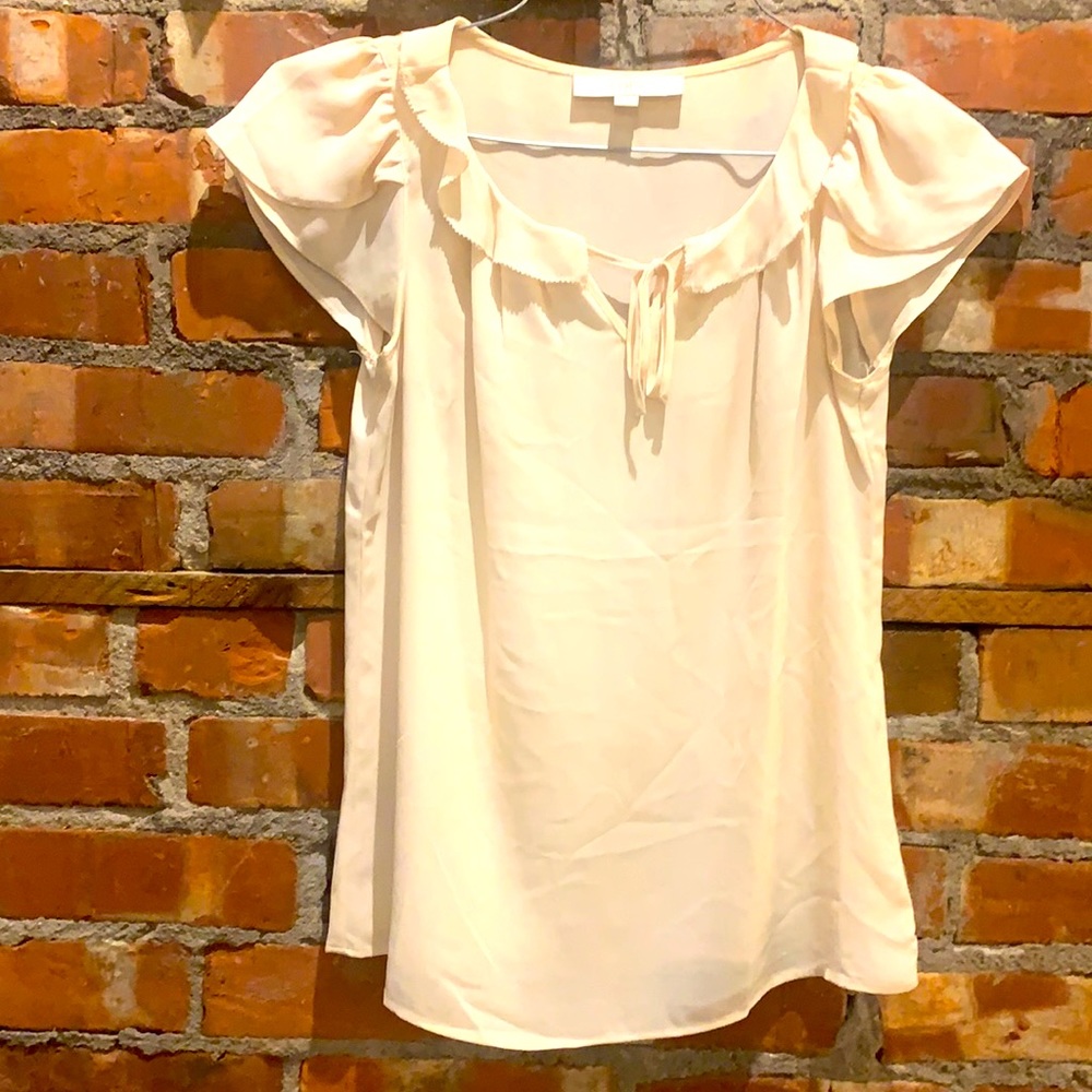 Ann Taylor -Loft. Beige colored polyester blouse with ruffles and tie. - XSP